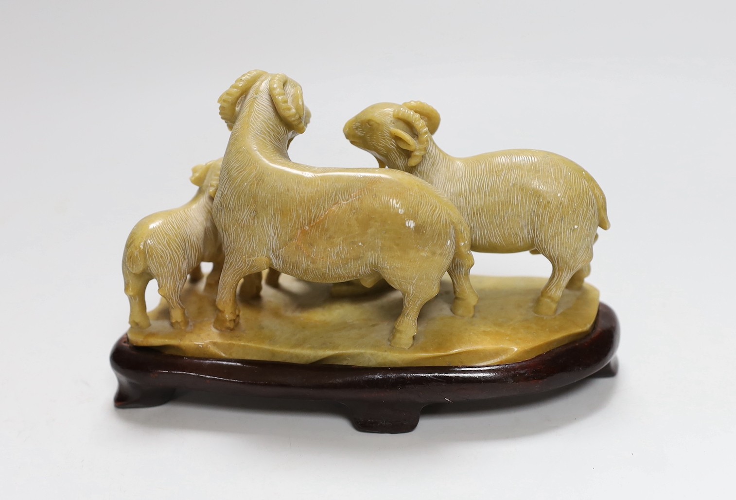 A Chinese carved soapstone ram and lamb group, on plinth, 11cms high